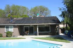 Solar panels installed on roof of home with swimming pool