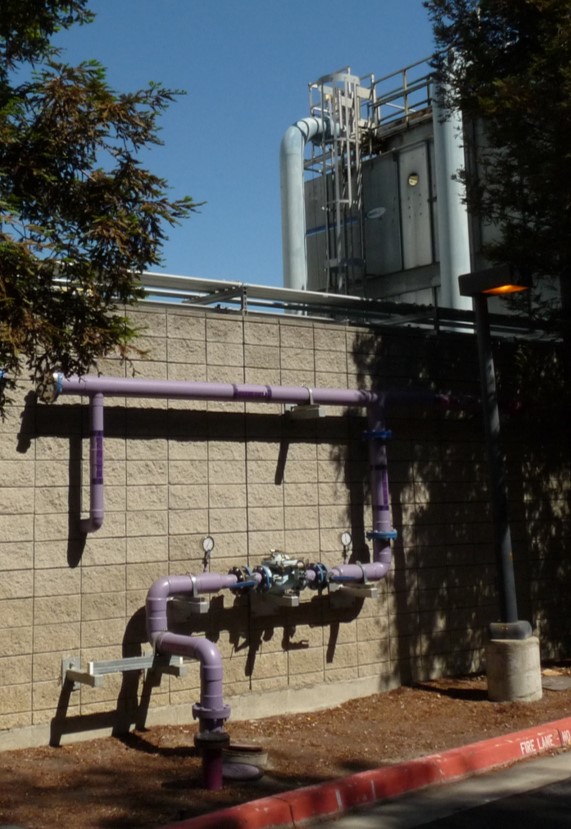 Recycled water lines on exterior of industrial building