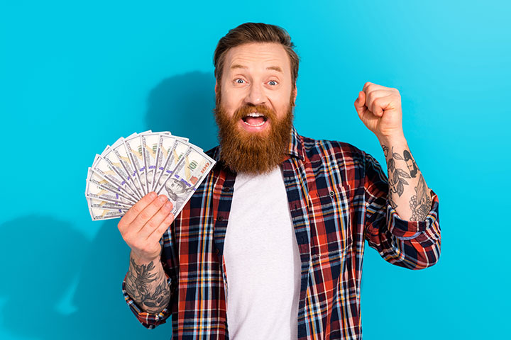 Man-in-flannel-holding-100-dollar-bills-web