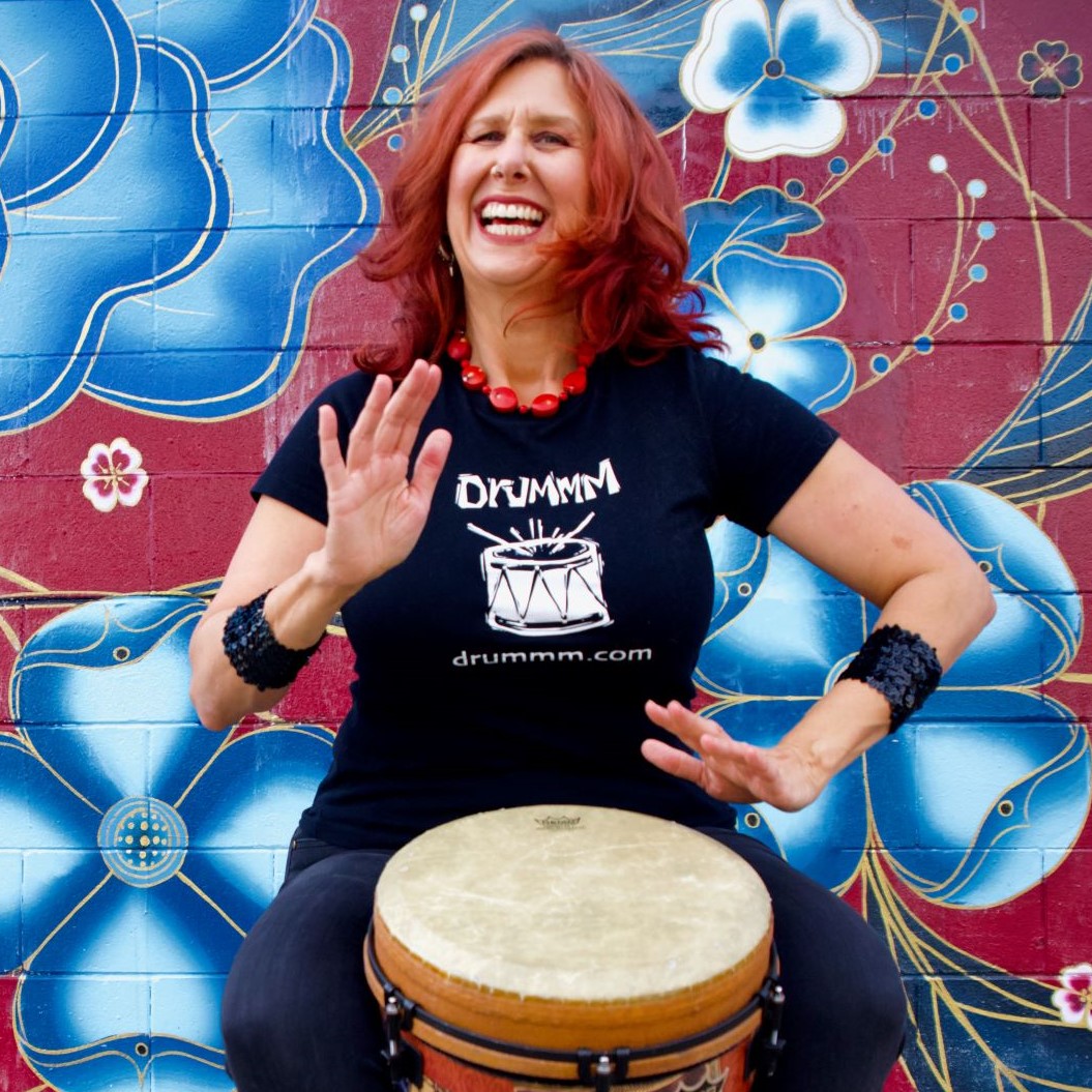 Jeni-Swerdlow-DRUMMM_Headshot-with-Remo-djembe-Oakland-mural-2021-resize.jpeg-2